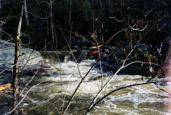 Greg runs a drop towards the bottom. The sticky hole to his right signals the start of the longest continuous section on the creek, with few eddies between the small individual drops. The final section, immediately after a huge landslide on the left, is particularly janky and may require a brief portage at low to medium water.