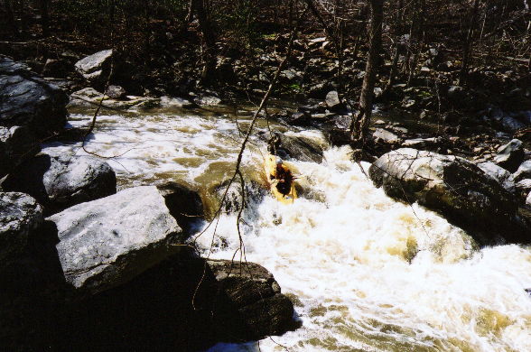 Brian once again showing the line. This rapid was fairly long, it was best run over a 4' boof just out of view to the above river right, then into the eddy on the left. Pinning rocks abounded just inches from Brian's boat.