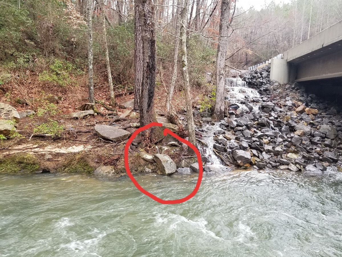 This rock might be used to judge the level at the put-in. Water barely touching the bottom means the creek is at ELF. However the rock is liable to move if the creek floods.