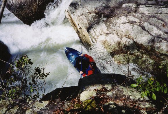Fred Westrom ran the slot above which leads to the cauldron drop. This picture is a neat optical illusion. He is actually going off an 8' drop into a cauldron with undercuts and much boiling water below. From a very low water run we made in March 2001.