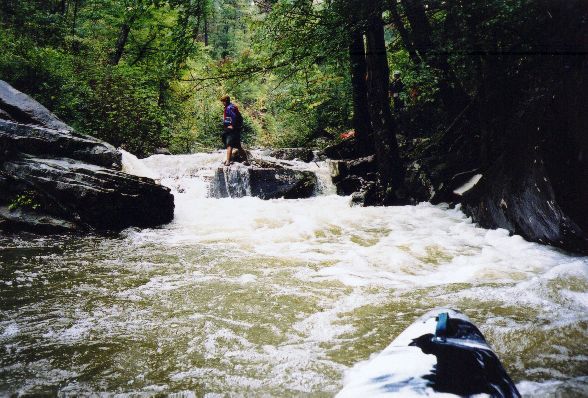 This was the most difficult rapid at about
4" on the river right CR275 gage.&nbsp; A good lean as you deflected off
the boulder the water slams into is required.&nbsp; The wall on river left
in front of the bow in this picture is undercut, to add a little penalty
term to the equation.&nbsp; Not all lines were clean on this run.
&nbsp;