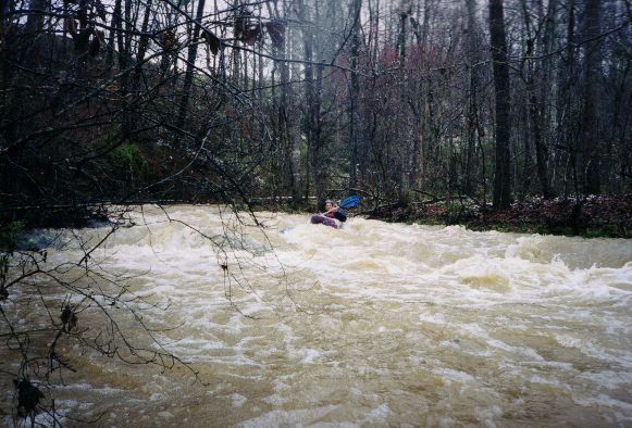 Kevin Cunningham in a typical conveyor
belt section looking to catch an eddy.&nbsp; Note the snow on shore.