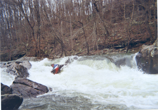 Chris V. biting it at Munch Stop. The rock on the bottom left of this picture can pin if you wash down the chute and there is a powerful hole beside the undercut boulder. (200 cfs on the Scarham gage) (J.C. Goodwin)