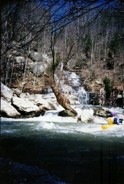 Jim Dowdy surfing across from a pretty waterfall coming into Scarham